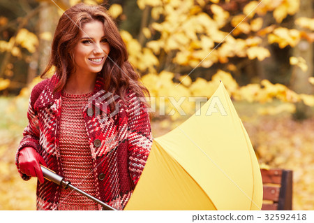season and people concept - beautiful happy young woman walking 32592418