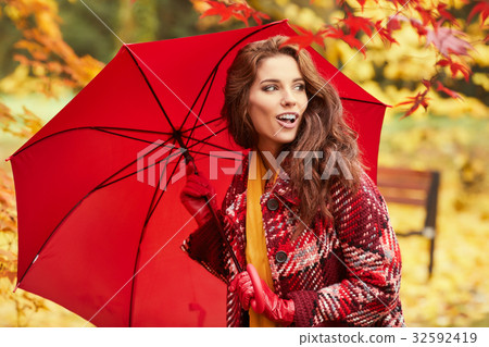season and people concept - beautiful happy young woman walking 32592419