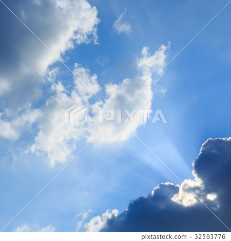 sunbeam of sunlight through clouds on blue sky 32593776