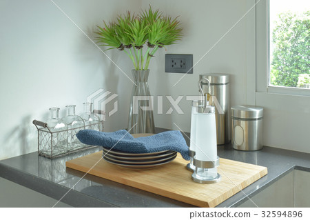 Dishes and bottles on black counter top in kitchen Dishes and bottles on black counter top in kitchen 32594896