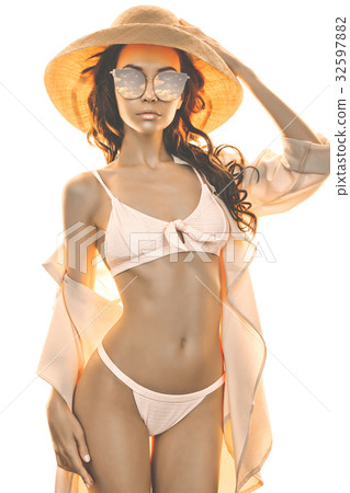 Beautiful slender woman in bikini and straw hat 32597882