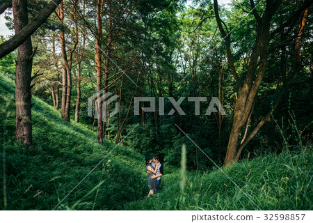 couple hugging while standing in the middle of the 32598857