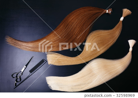 hair extensions of three colors on a dark 32598969