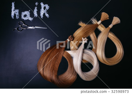 hair extensions of three colors on a dark 32598973