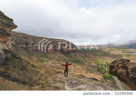 Tourist standing with outstretched arms Tourist standing with outstretched arms 32599300