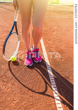 Female legs with tennis racket 32599762