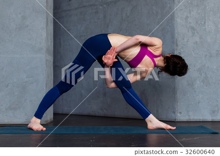 Rear view of young female yogi in sports bra and Rear view of young female yogi in sports bra and 32600640