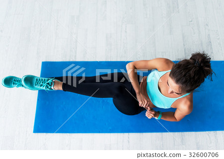 Top view of young fit woman working-out doing Top view of young fit woman working-out doing 32600706