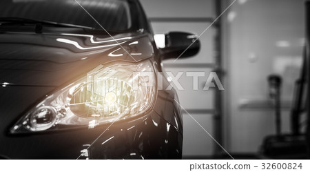 Black modern car on black background. 32600824