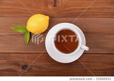 Cup of tea and lemon with leaves Cup of tea and lemon with leaves 32600932
