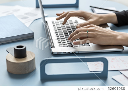 Girl using laptop in office Girl using laptop in office 32601088