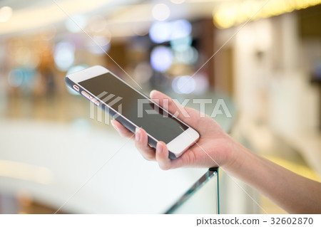 Woman holding on cellphone Woman holding on cellphone 32602870