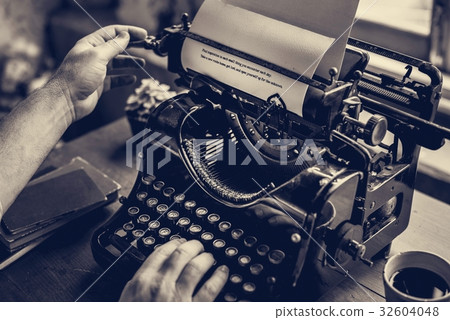 Hands typing on classic vintage typewriter Hands typing on classic vintage typewriter 32604048