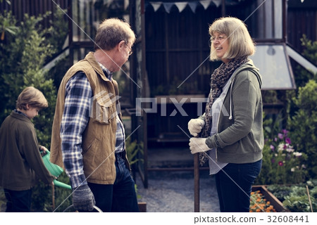 Senio rcouple with little boy gardening at home backyard Senio rcouple with little boy gardening at home backyard 32608441