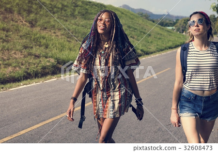 Group of Diverse Backpacker Women Walking along The Street Side 32608473