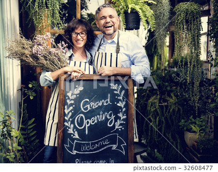 Adult Man and Woman Standing with Grand Opening Sign 32608477