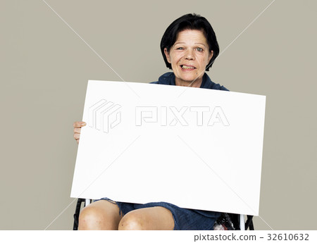 Senior adult woman on wheelchair holding blank banner 32610632