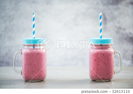 Two vintage jars with berry smoothie Two vintage jars with berry smoothie 32613110