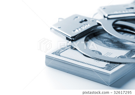 Pair of handcuffs on dollar and euro banknotes 32617295