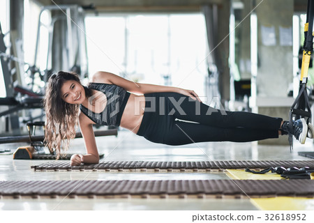 young asia girl stretching with TRX in the gym young asia girl stretching with TRX in the gym 32618952