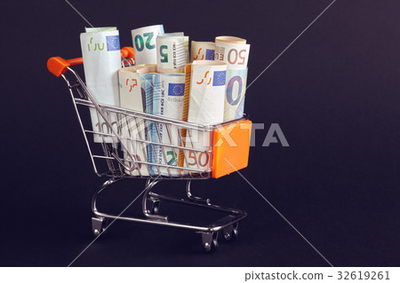 Shopping cart filled with Euro bill rolls. Shopping cart filled with Euro bill rolls. 32619261