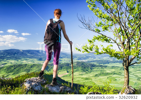 Woman watching from top of the hill Woman watching from top of the hill 32620932