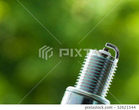 Auto service. New spark plug as spare part of car. 32621544
