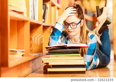 Woman student in college library Woman student in college library 32621834