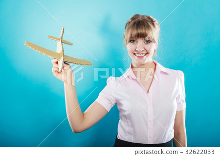 woman thinking about vacation holds airplane woman thinking about vacation holds airplane 32622033