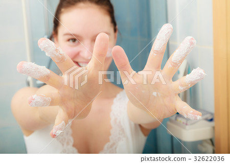 Woman with moisturizing skin cream. Skincare. 32622036