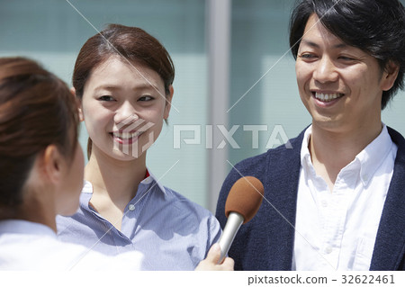 A couple receiving a street interview 32622461