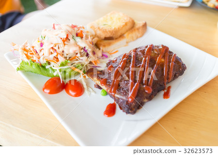 pork barbecue ribs with barbecue sauce and bread 32623573