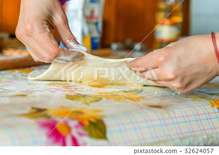 Woman hands kneading dough on the table Woman hands kneading dough on the table 32624057