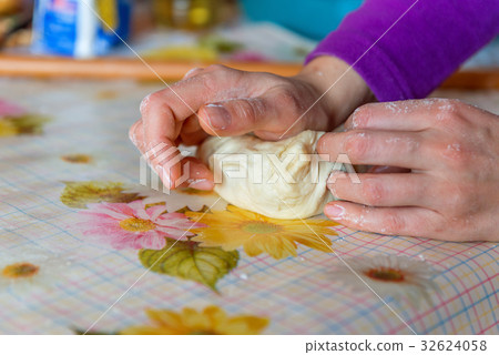 Woman hands kneading dough on the table Woman hands kneading dough on the table 32624058