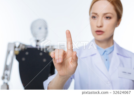 Serious scrupulous woman clicking on invisible Serious scrupulous woman clicking on invisible 32624067