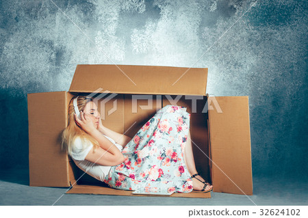 Introvert concept. Woman sitting inside box and Introvert concept. Woman sitting inside box and 32624102