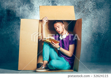 Introvert concept. Man sitting inside box and Introvert concept. Man sitting inside box and 32624115