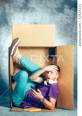 Introvert concept. Man sitting inside box and Introvert concept. Man sitting inside box and 32624131