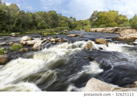The rapid river, rocky rapids green vegetation sky The rapid river, rocky rapids green vegetation sky 32625113