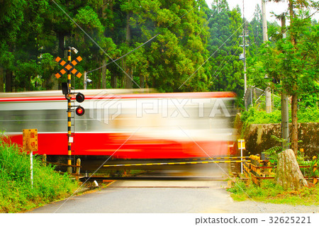 A train passing through a railroad crossing A train passing through a railroad crossing 32625221