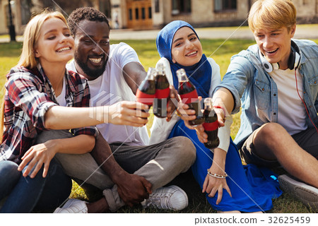 图库照片: enthusiastic optimistic friends clanging their