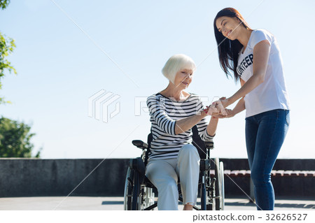 Committed engaging volunteer securing elderly Committed engaging volunteer securing elderly 32626527