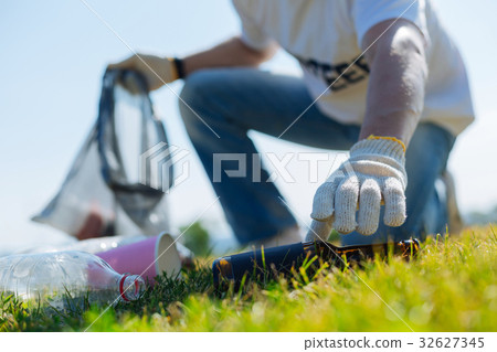 Attentive productive man removing rubbish Attentive productive man removing rubbish 32627345