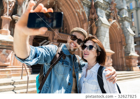 Cheerful youthful couple using gadget when Cheerful youthful couple using gadget when 32627825