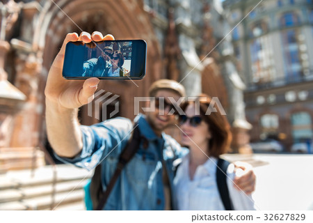 Jolly youthful lady and bearded guy making selfie Jolly youthful lady and bearded guy making selfie 32627829
