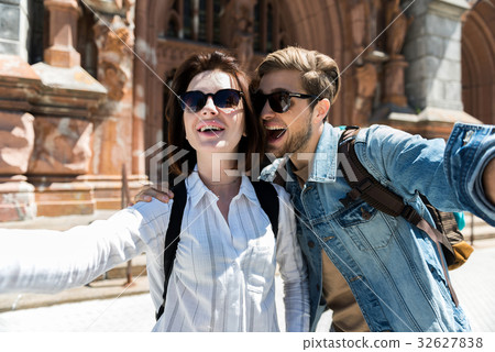 Cheery youthful woman and bearded guy having fun Cheery youthful woman and bearded guy having fun 32627838