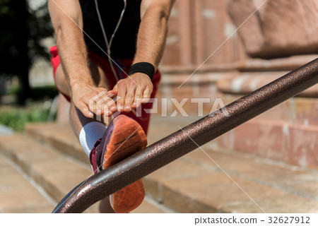 Young sportsman practicing outdoors on city ladder 32627912