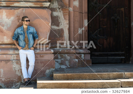Cheerful youthful man with beard sightseeing in 32627984