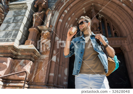 Cheery youthful guy with beard enjoying Cheery youthful guy with beard enjoying 32628048