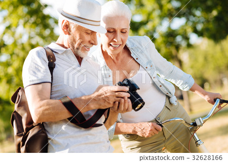 Positive delighted couple choosing best photos 32628166